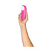Hand holding a pink Womanizer Starlet 3 clitoral stimulator with white silicone head on a white background