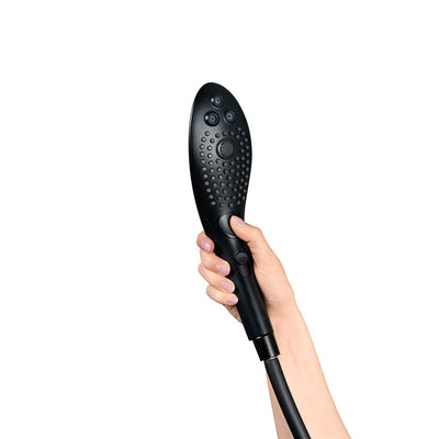 Hand holding a sleek black Womanizer Wave shower head with multiple water jet nozzles and ergonomic design.