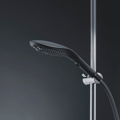 Sleek black Womanizer Wave shower head mounted on chrome shower bar with flexible hose against dark background.