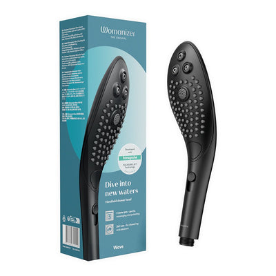 Black Womanizer Wave handheld shower head with silicone nozzles shown next to its blue and white packaging box.