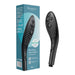 Black Womanizer Wave handheld shower head with silicone nozzles shown next to its blue and white packaging box.