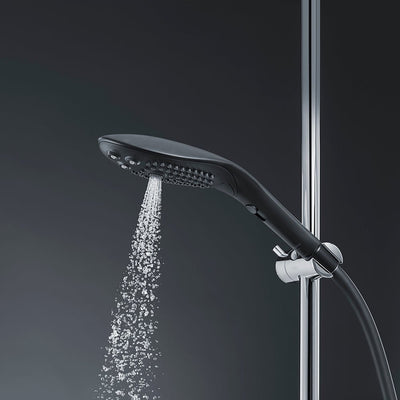Black Womanizer Wave shower head with water flowing, mounted on chrome shower rail against dark background.