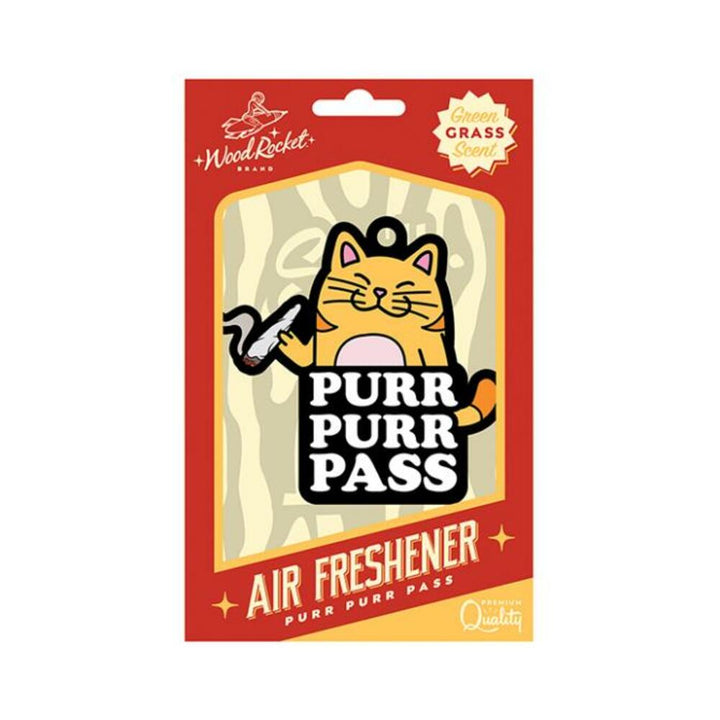 Wood Rocket Purr Purr Pass air freshener with cartoon cat design and green grass scent in red and yellow packaging.