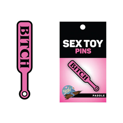 Pink enamel lapel pin shaped like a paddle with the word "BITCH" in black letters, displayed on branded backing card.
