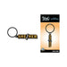 Black and gold enamel keychain with "She/Her" text, displayed loose and on branded Wood Rocket packaging.