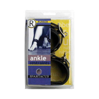 Black rubber ankle restraints with metal D-rings in clear retail packaging by Spartacus.