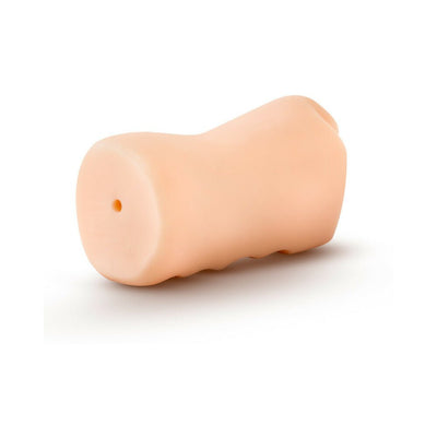 Compact beige TPE mouth stroker with textured grip and small opening on white background.