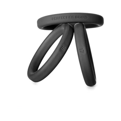 Set of three black silicone cockrings in medium to large sizes with size markings and smooth finish.
