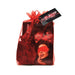 Red organza gift bag containing You & Me silky red blindfold and fabric rose petals for romantic settings.