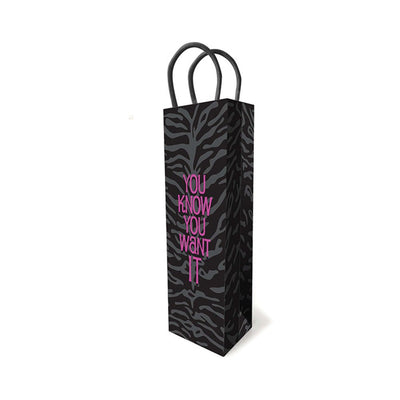 Black wine-size gift bag with dark tiger stripe pattern and magenta foil text "You Know You Want It" with black woven handles.