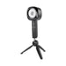 Black Zero Tolerance Let It Slide rechargeable stroker with ergonomic handle on a small tripod stand against white background.