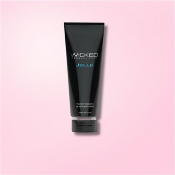 Black tube of Wicked Jelle water-based anal lubricant with minimalist design on a light background.