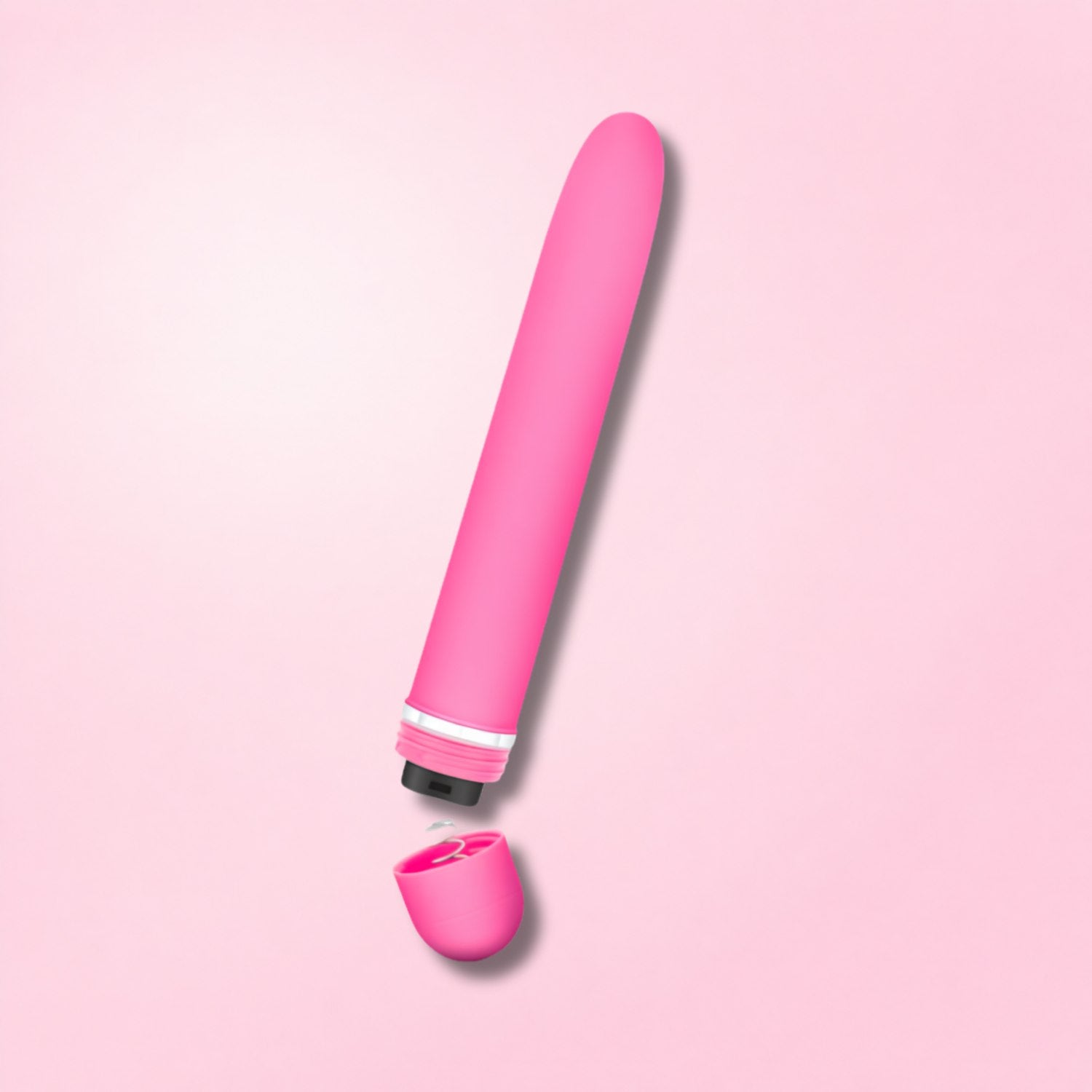 Slim metallic pink and silver classic vibrator with textured grip and jewel-like base detail on gradient background.