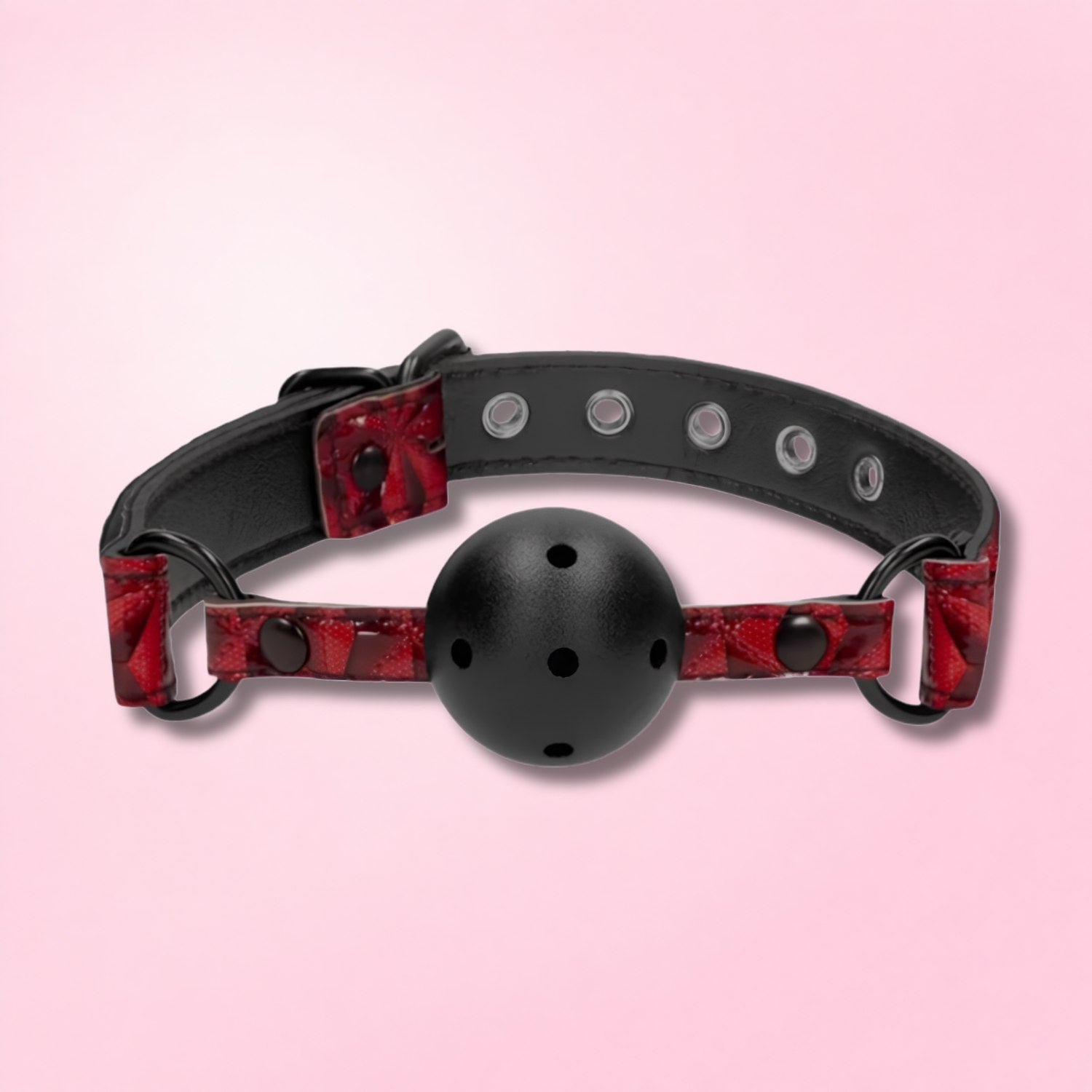 Woman wearing a black textured blindfold with finger to lips against a dark red background.