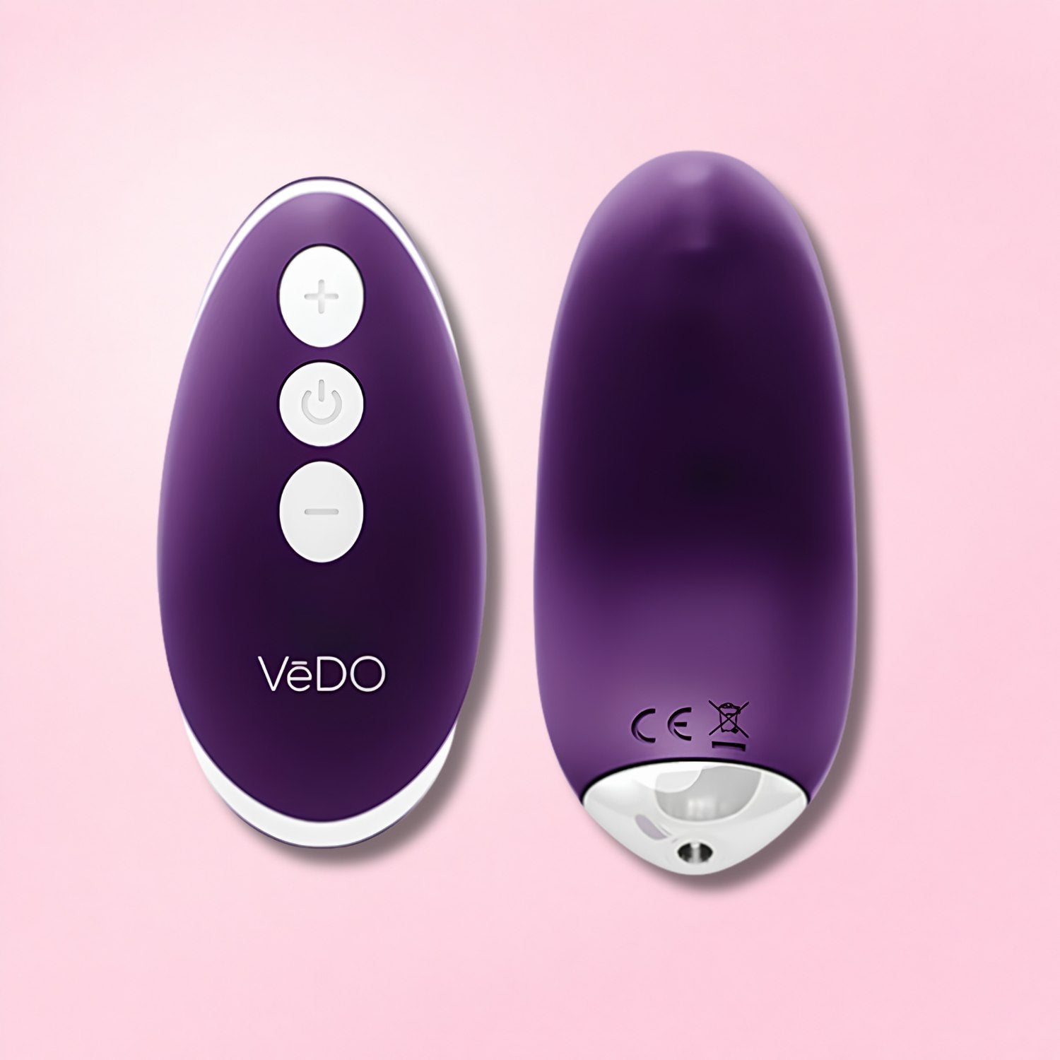 Black remote-controlled vibrator with curved tip and compact wireless remote on gradient background.