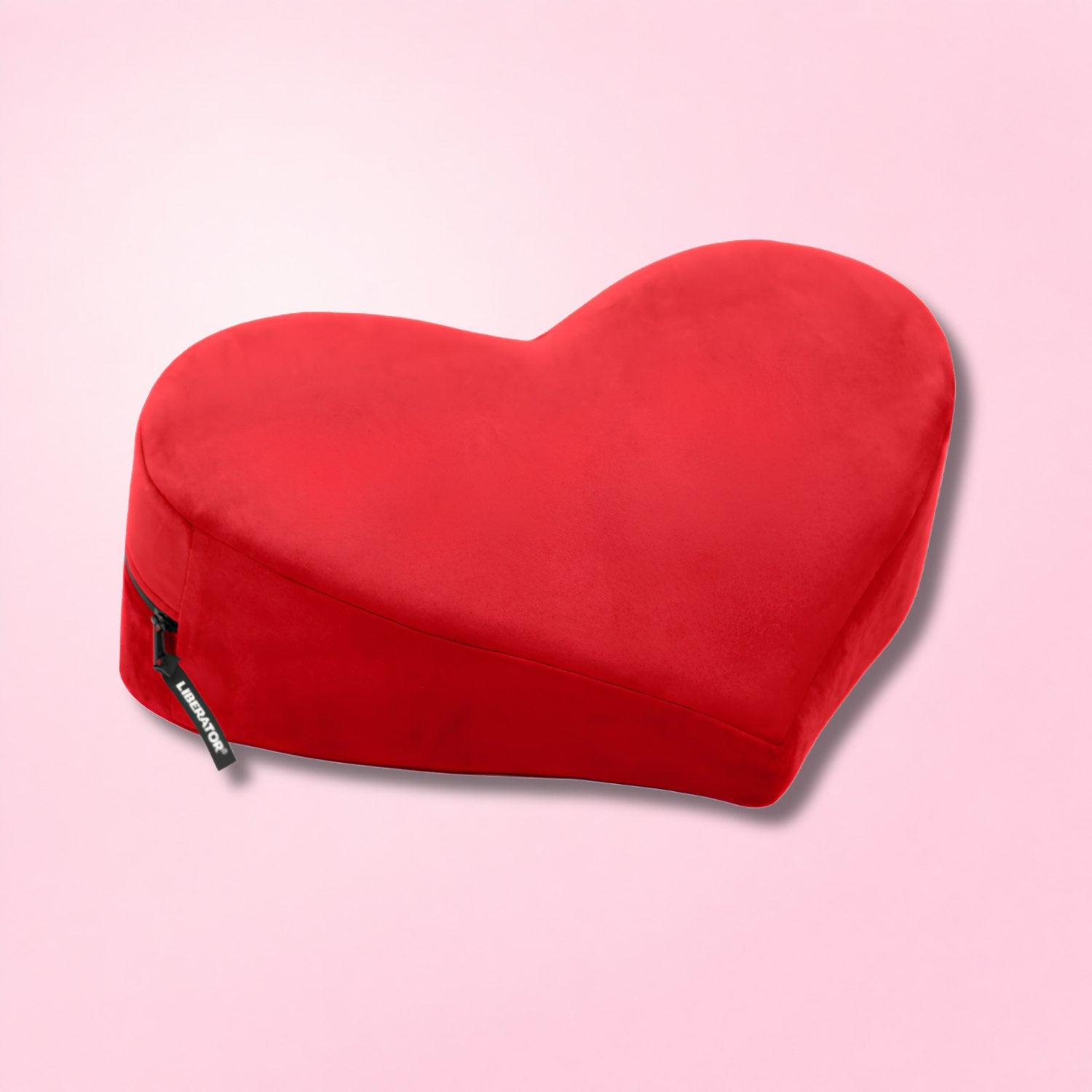 Black adjustable bondage bench with padded sections and attached restraints on a red textured background.
